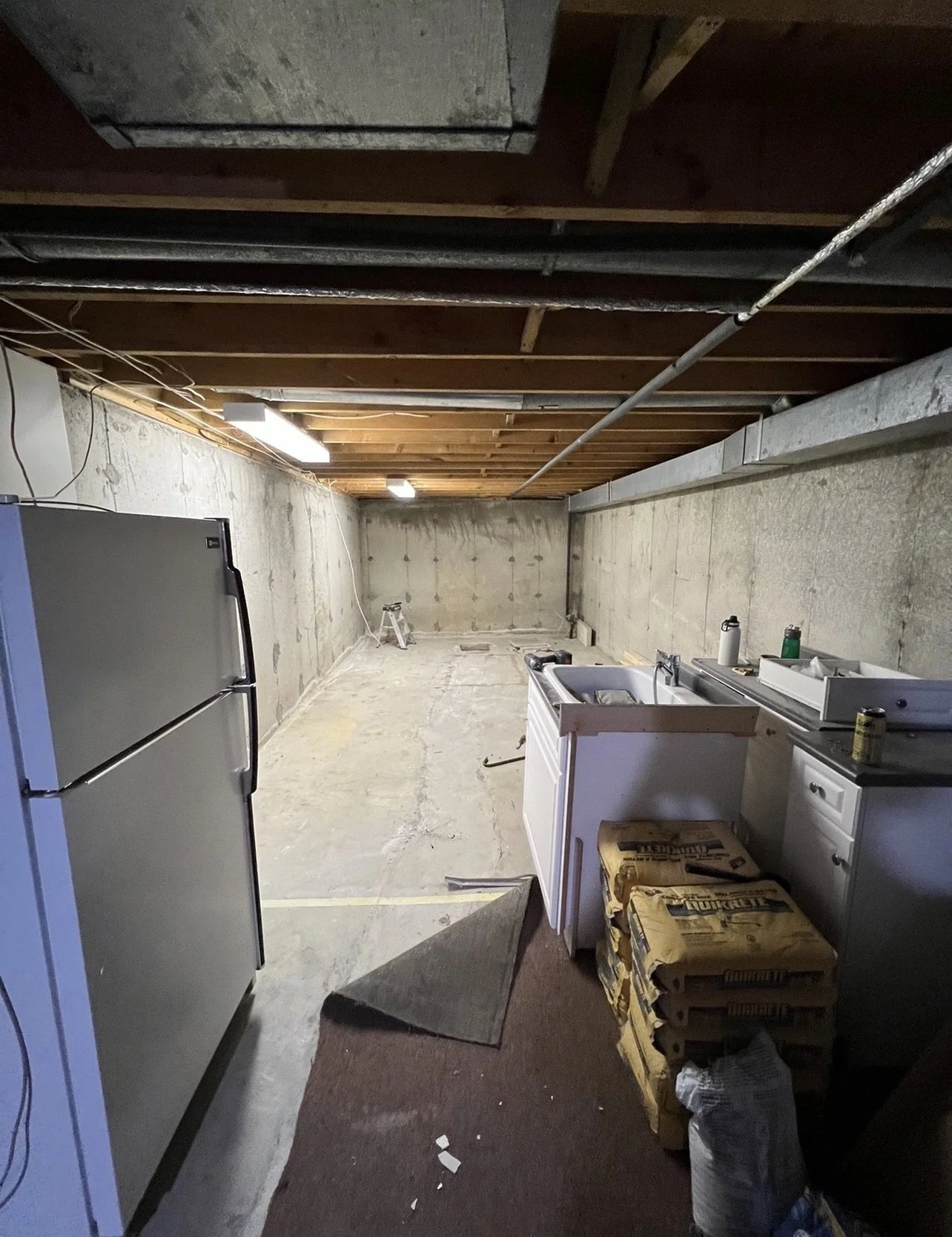 Another before picture of the unfinished basement in West London prior to renovation by Burcon Construction, showing the space awaiting renovation.