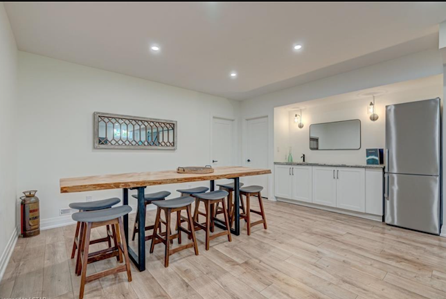 Completed bar area in Komoka basement renovation by Burcon Construction, featuring sleek granite wet bar and modern design.