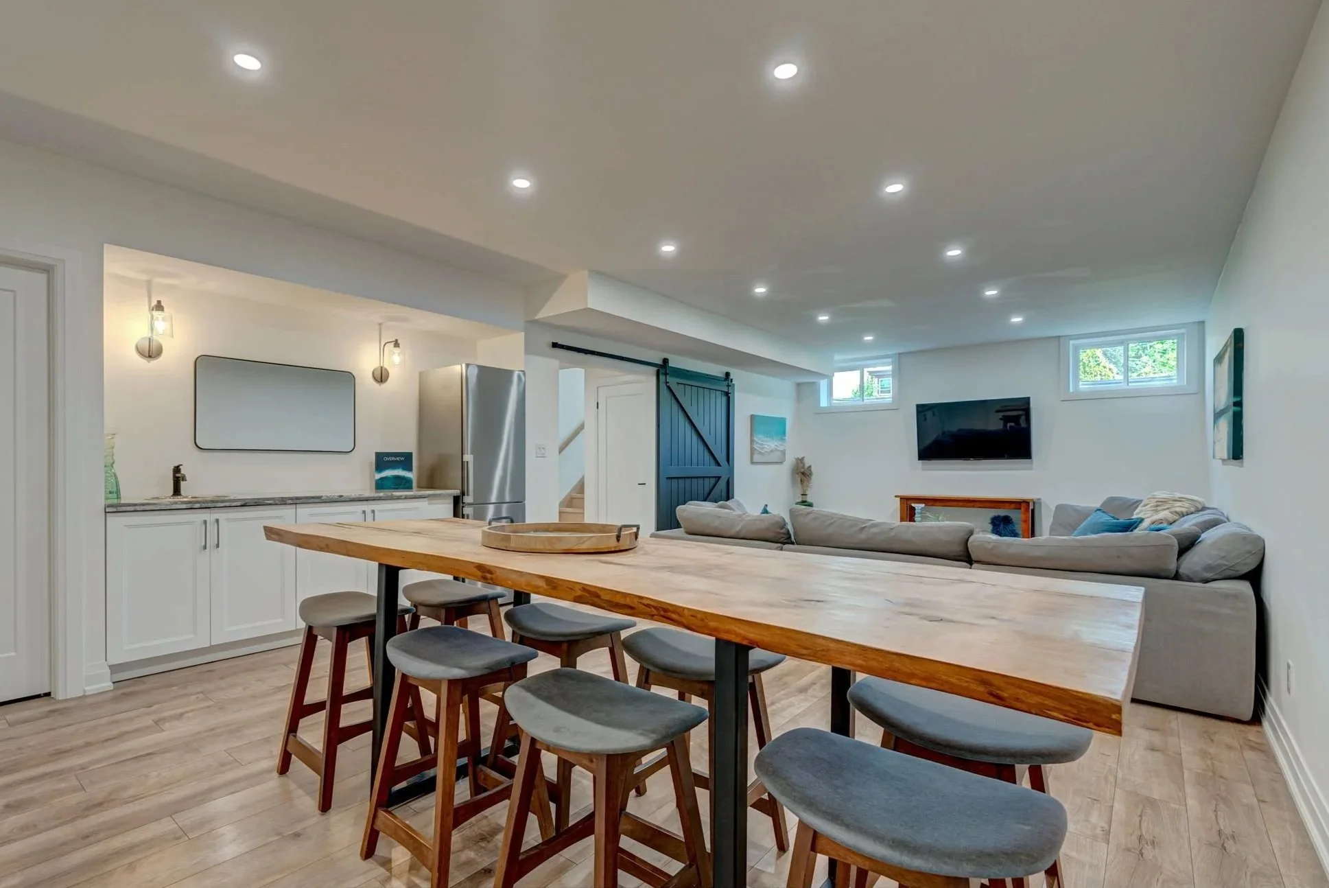 Finished bar and living area in Komoka basement renovation by Burcon Construction, showcasing functional space and stylish design.