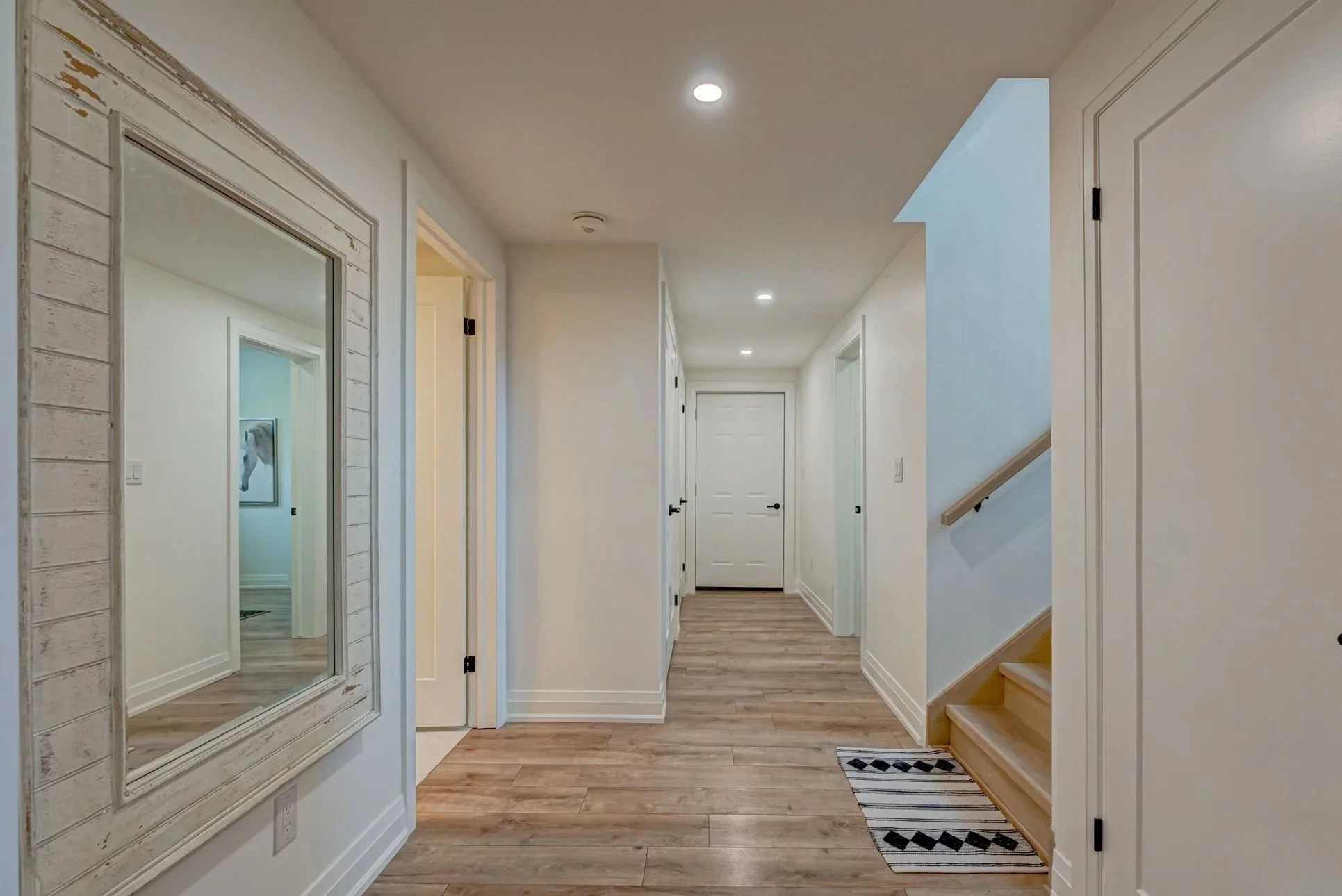 Finished hallway in Komoka basement renovation by Burcon Construction, providing access to various rooms and areas.