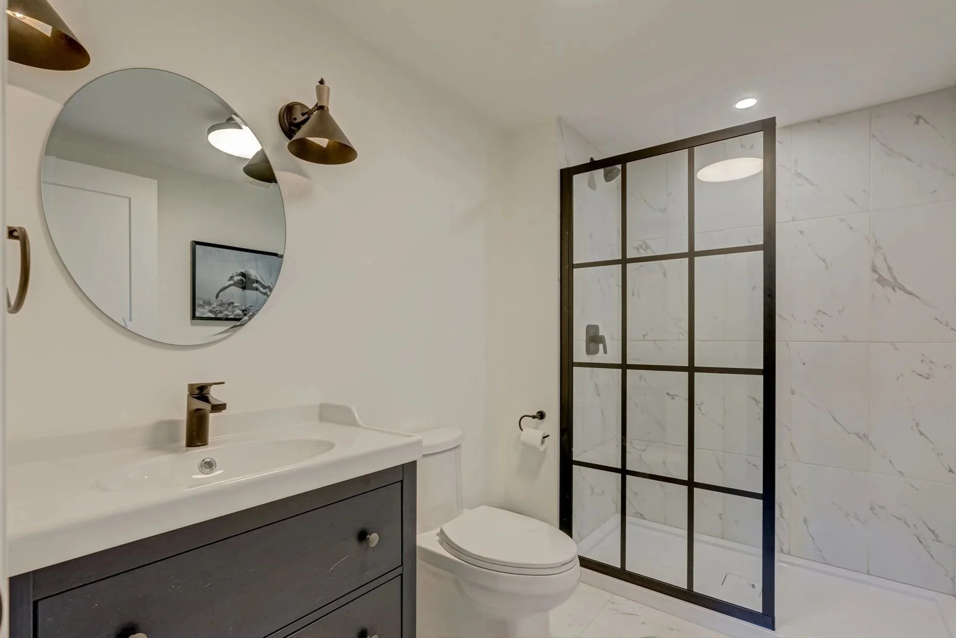 Completed bathroom in Komoka basement renovation by Burcon Construction, featuring modern fixtures and practical design.