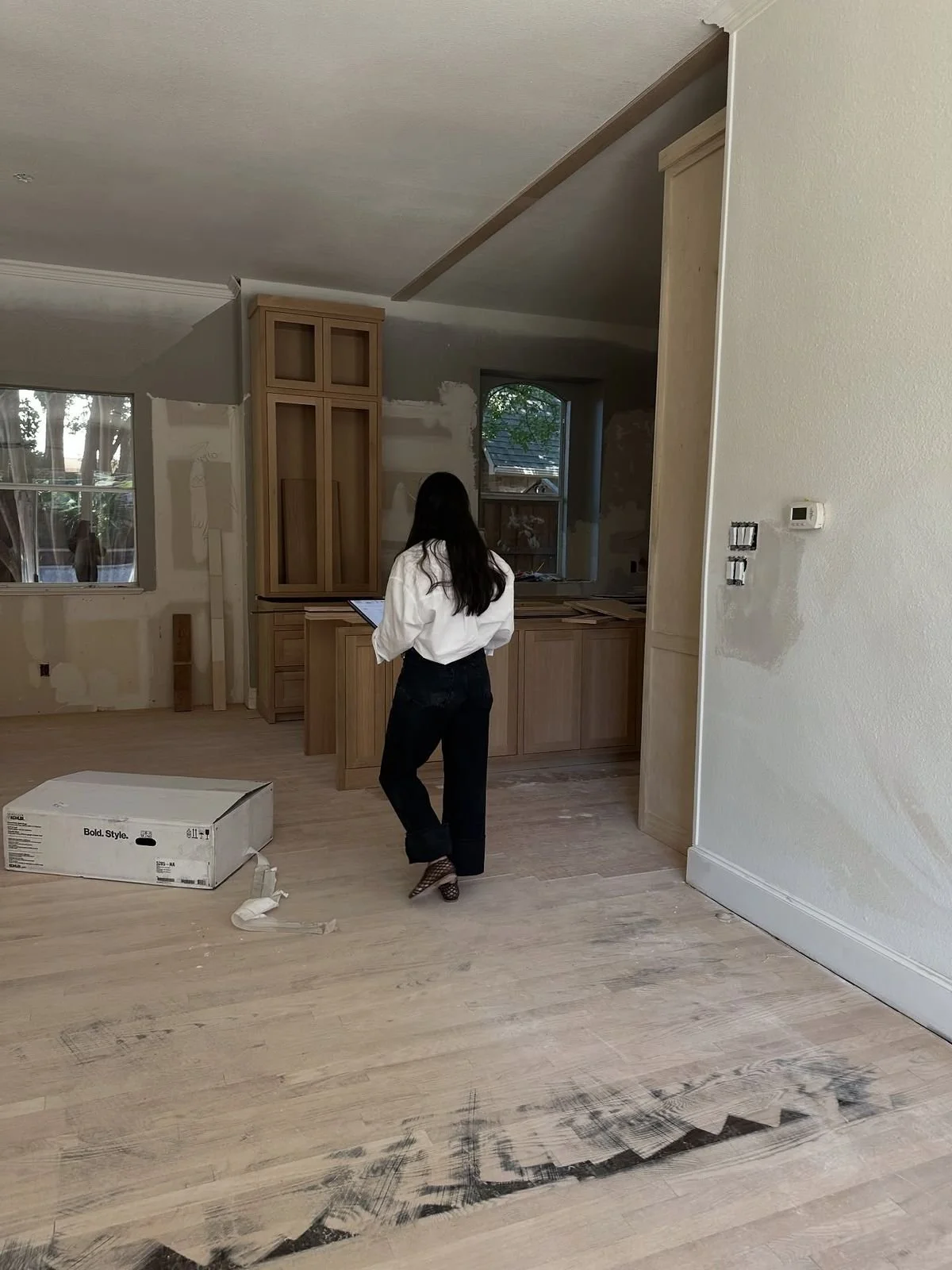 Professional interior designer overseeing a kitchen renovation with custom cabinetry in the San Francisco Bay Area and South Bay.