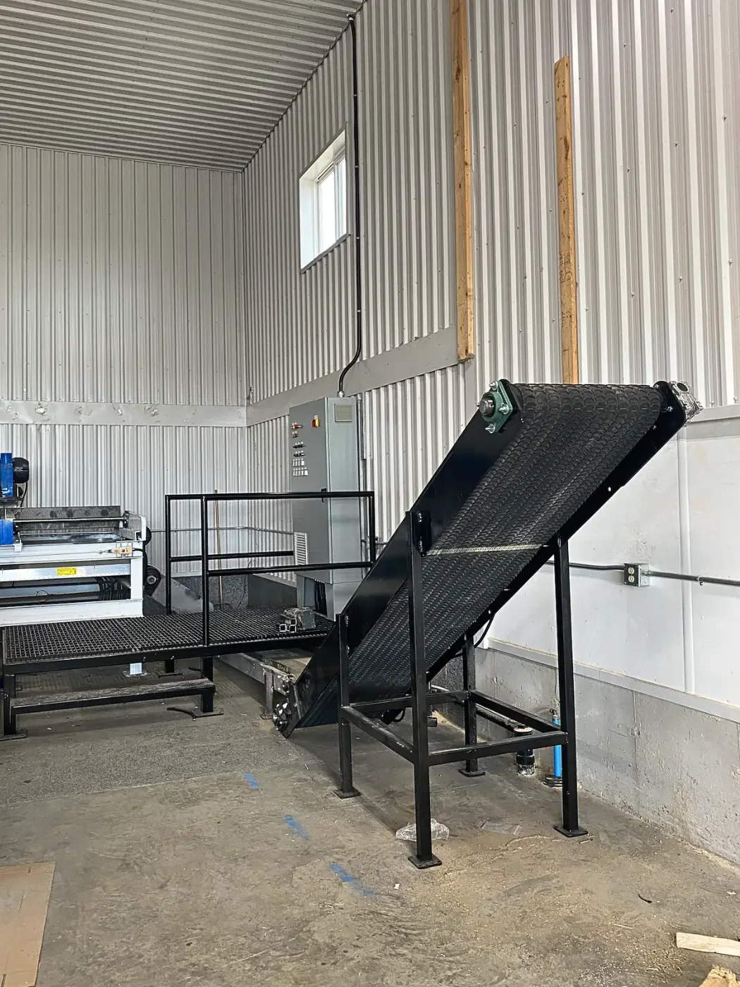 Custom offcut conveyor manufactured for sawmill material handling, designed to improve material flow and production efficiency
