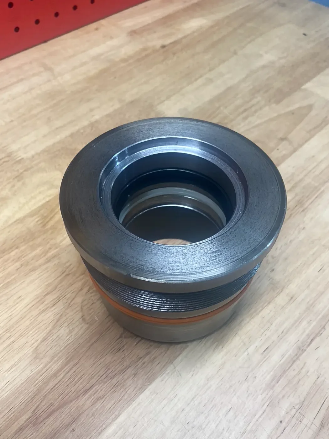 Custom 4140 hydraulic gland precision-machined for a 2.5-inch rod and 4-inch bore hydraulic cylinder.