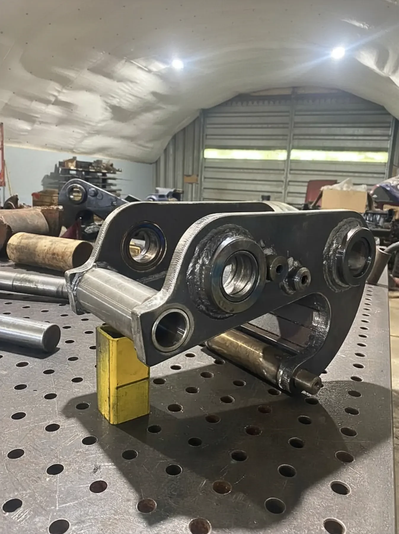 Custom 4140 excavator quick attach bushing manufactured for heavy equipment repair and replacement.