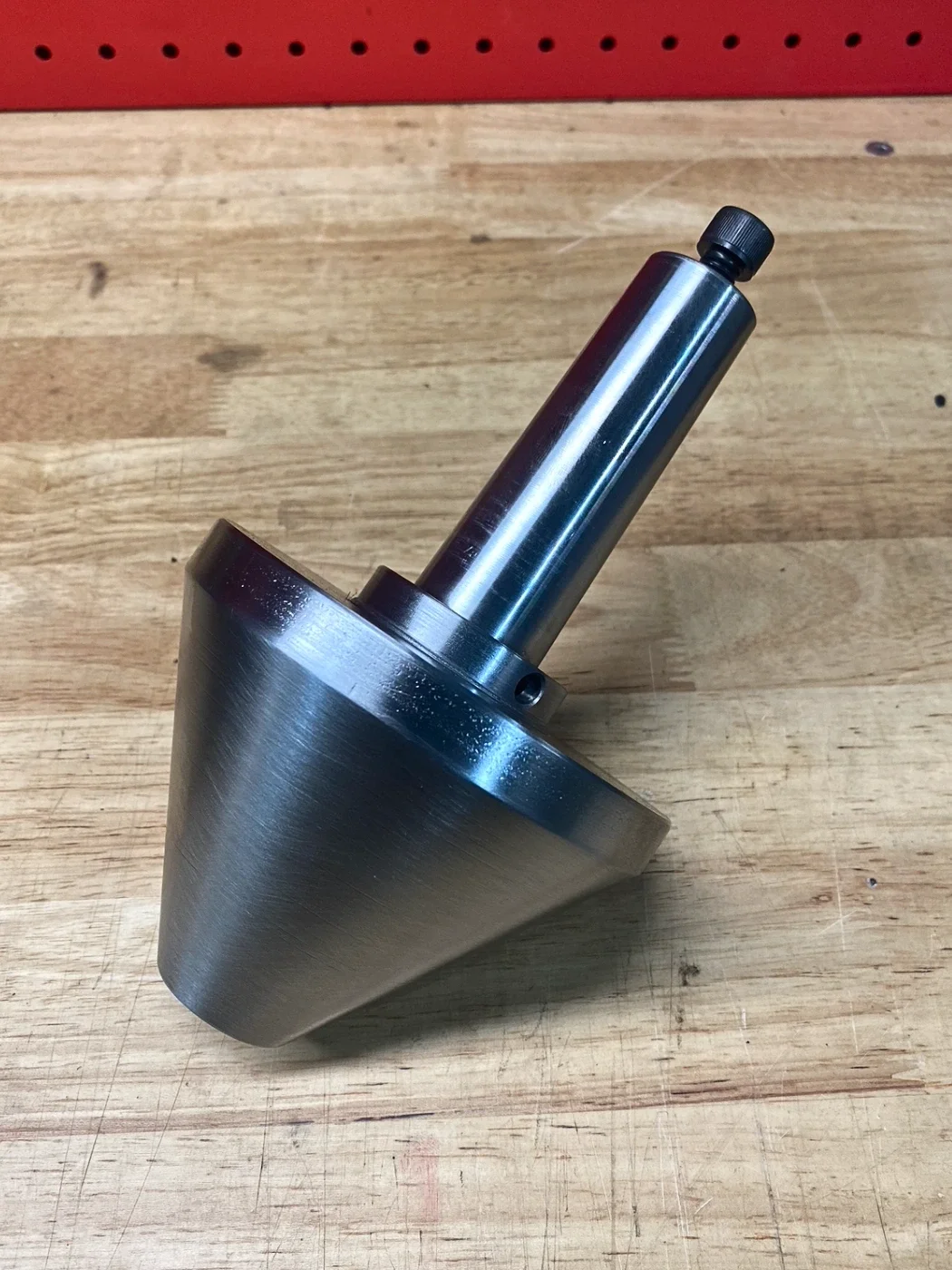 Custom machined 4140 steel bull centre used to support workpieces during lathe turning operation.