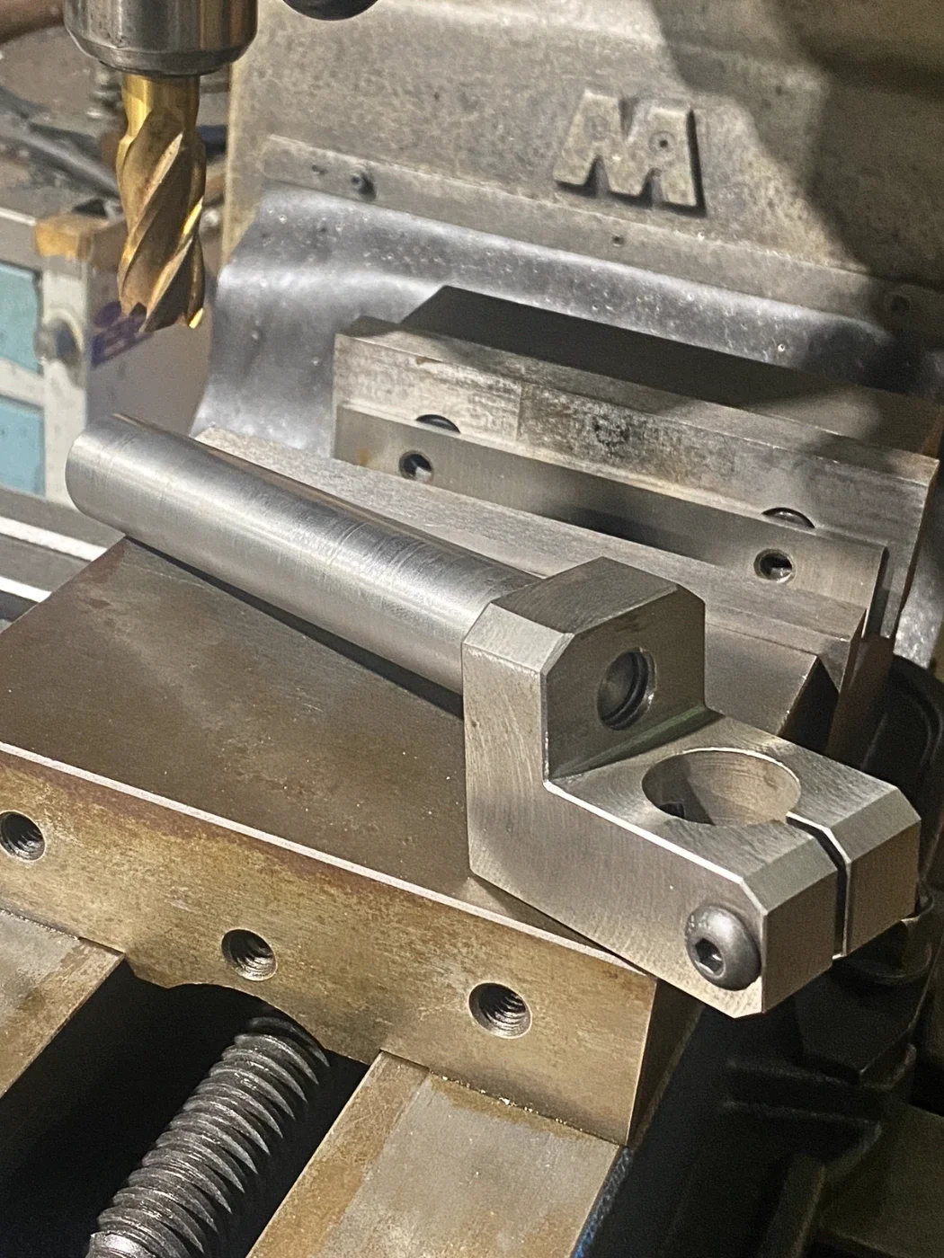 Custom machined fixturing arm designed to position and control components during manufacturing and fabrication operations