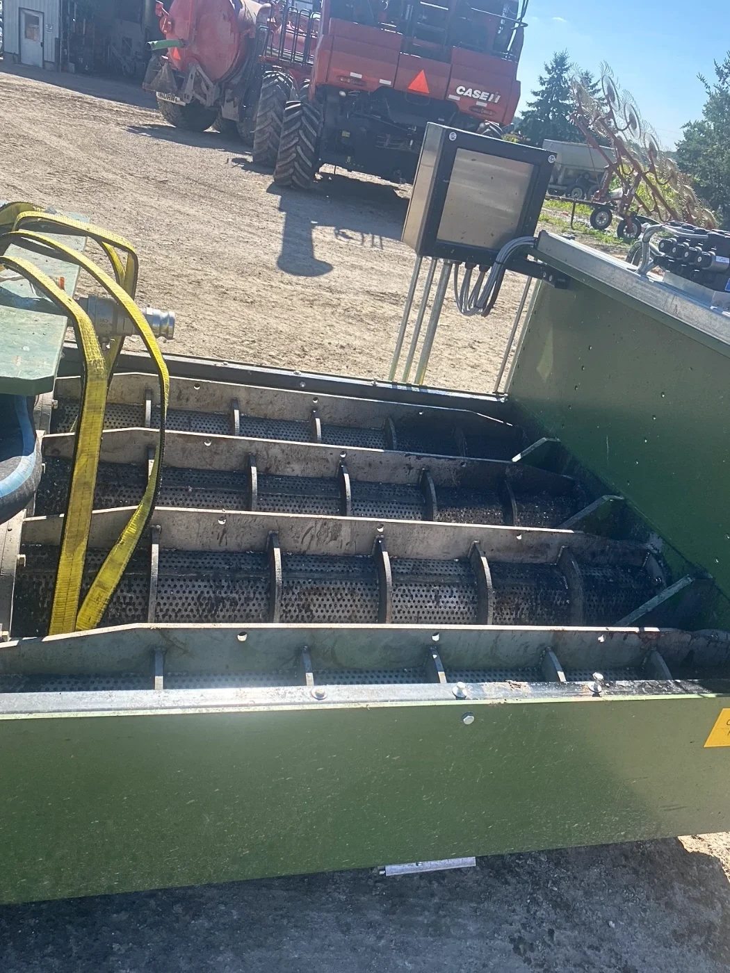 Top view of custom-built industrial garbage press designed to separate liquid from wet cardboard and packaging waste for recycling and waste processing applications.
