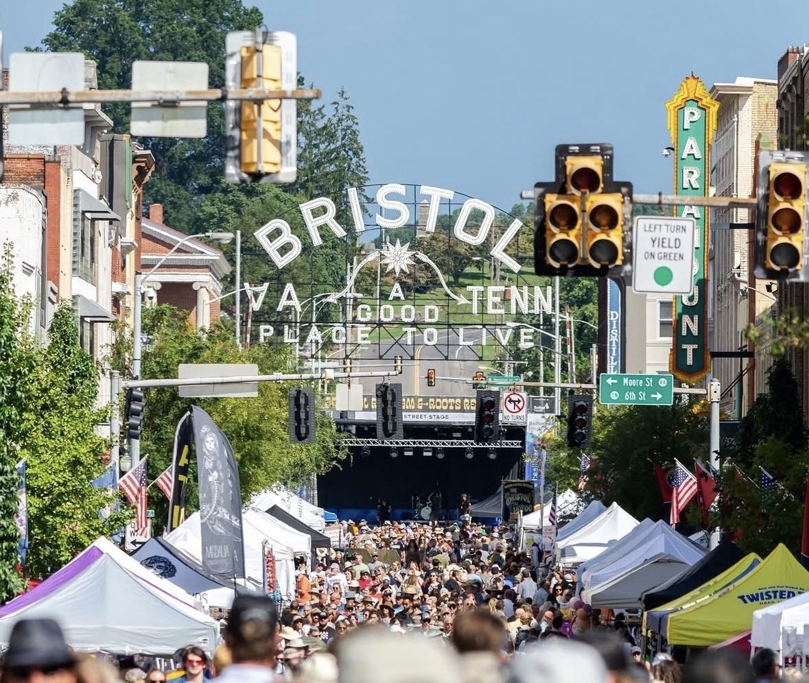 A crowded street backed by a large sign that says Bristol, A Good Place to Live