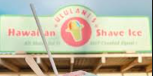 Hawaiian shave ice cart with a sign reading 'Hawaiian Shave Ice' and a logo featuring a cone with a smiley face.
