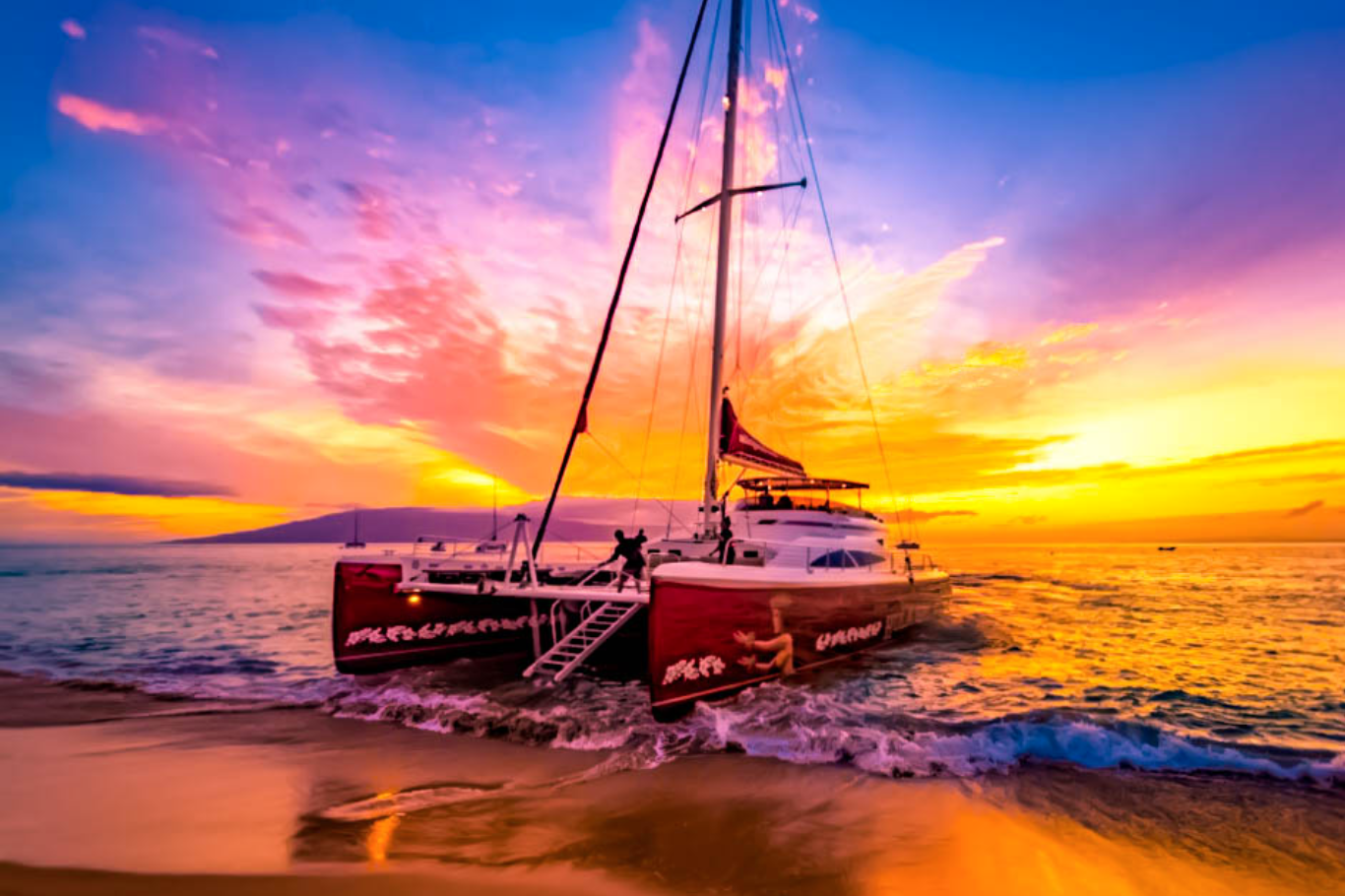 A sailboat on the beach during a colorful sunset with vibrant pink, orange, and purple sky, calm water, and a distant landmass.
