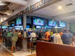 People watching sports on multiple TVs in a bar or restaurant.