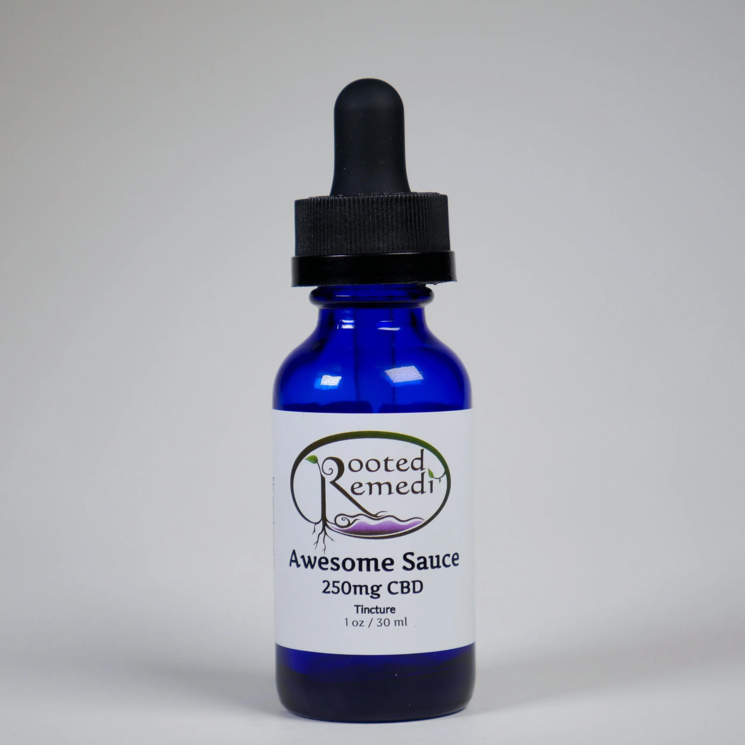 Dark blue glass bottle with dropper cap labeled 'Rooted Remedi Awesome Sauce 250mg CBD Tincture 1 oz / 30 ml' against a plain gray background.