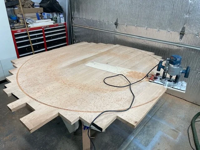 Cutting a round solid cherry dining table top. 