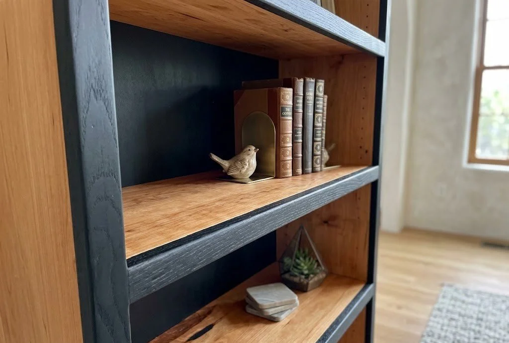 Handcrafted natural cherry and black oak satin frame bookshelf with adjustable shelves. 