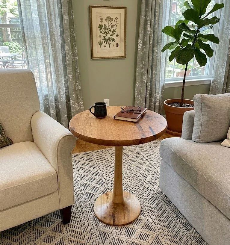 Modern hand-sculpted pedestal base round white oak wood top side table with close-to-the-wood finish.