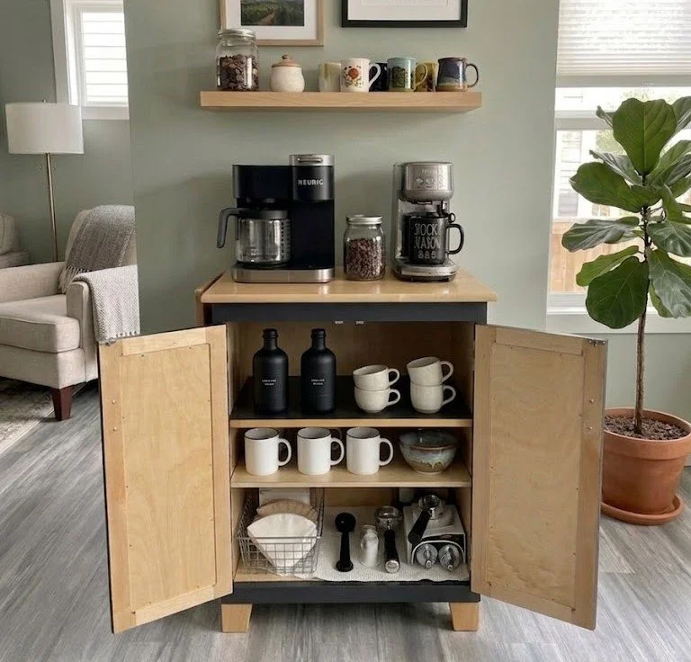 Free-standing coffee bar cabinet with natural wood top, painted base, and adjustable shelves. 