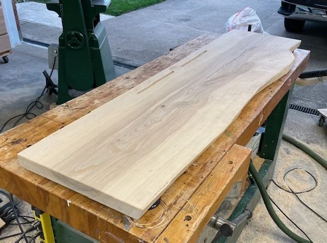 Live edge ash desktop with integrated cable management ready for a hand rubbed finish. 