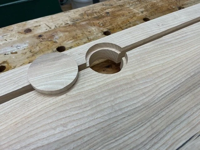 Integrated cable management solution on solid ash live edge desktop. 