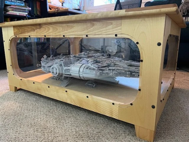 A custom wooden display case with a transparent cover, showcasing a detailed LEGO replica of a spaceship from Star Wars.