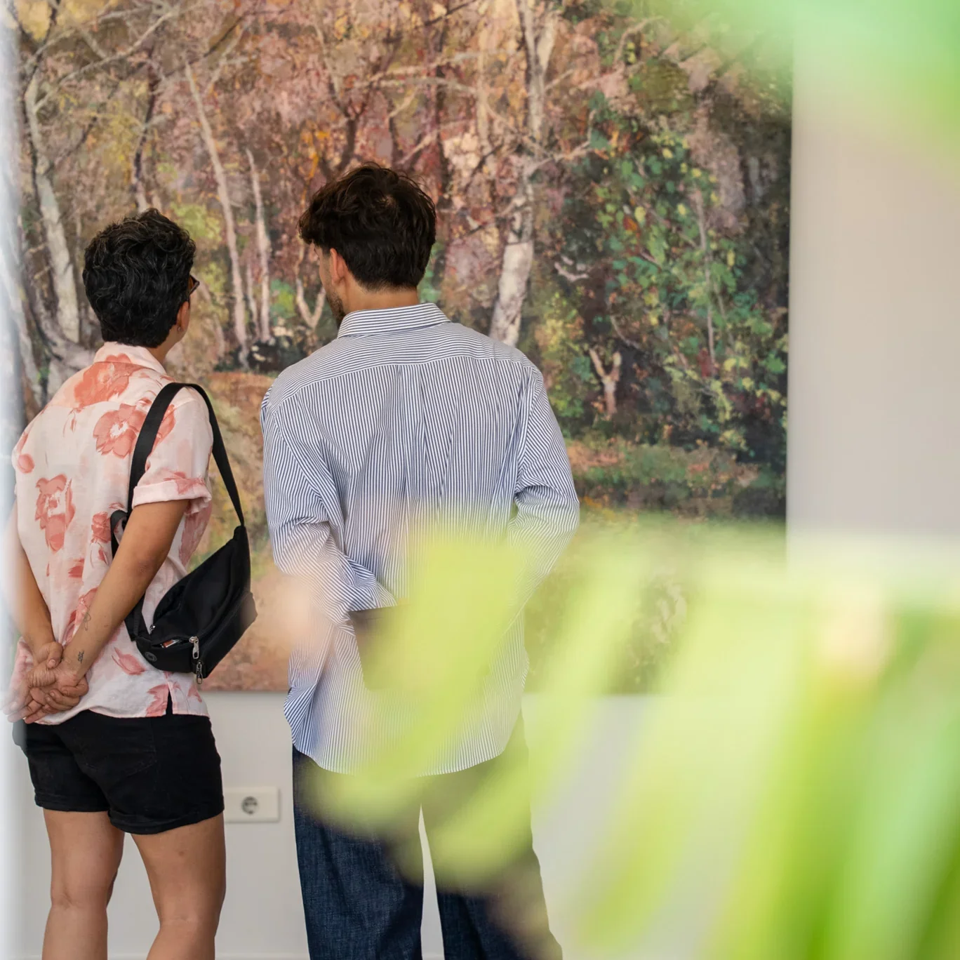 Visitors viewing a painting at a Zefta Arthouse exhibition