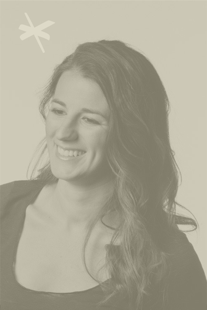 A woman with long wavy hair smiling, looking slightly to her left, against a plain background with a simplistic butterfly icon in the top left corner.