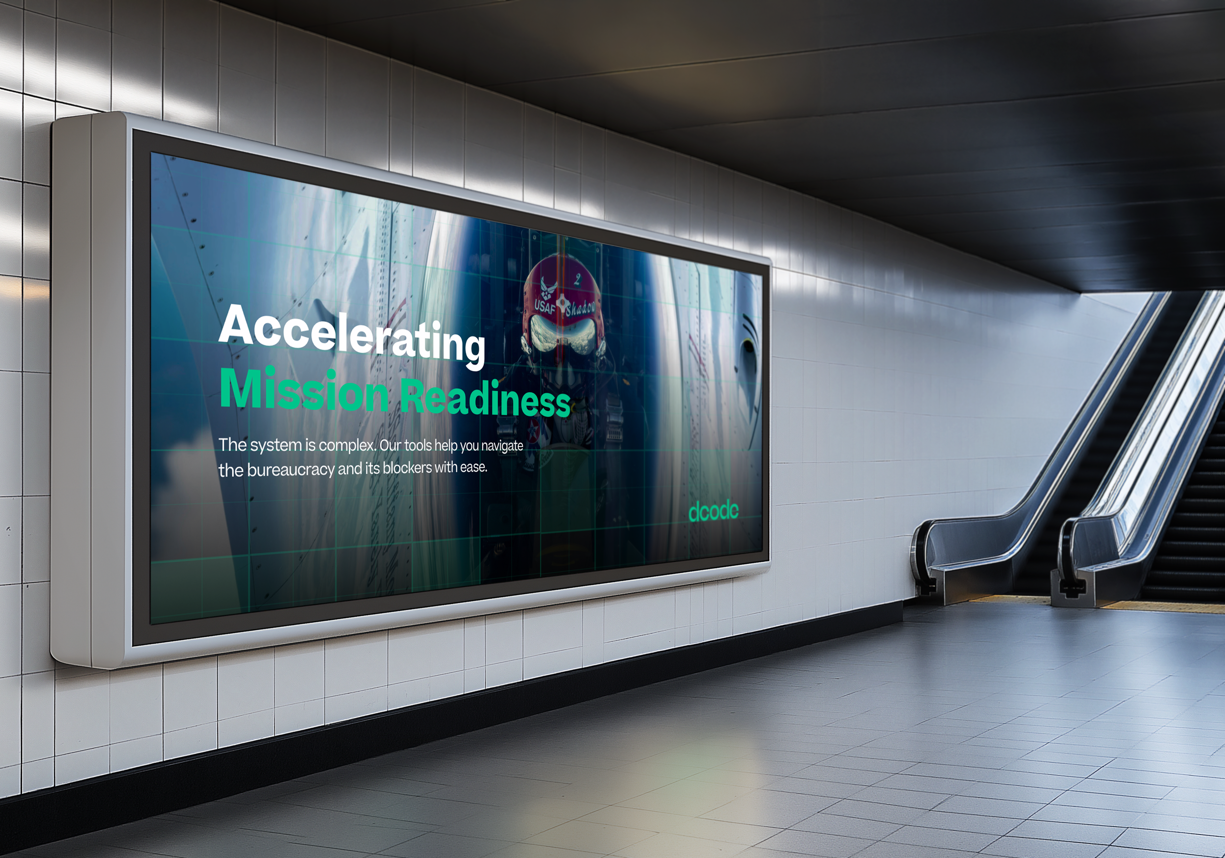 Digital advertisement in an underground metro station showing a pilot in uniform with back to a globe, with the text 'Accelerating Mission Readiness' and smaller text about tools for navigating bureaucracy.
