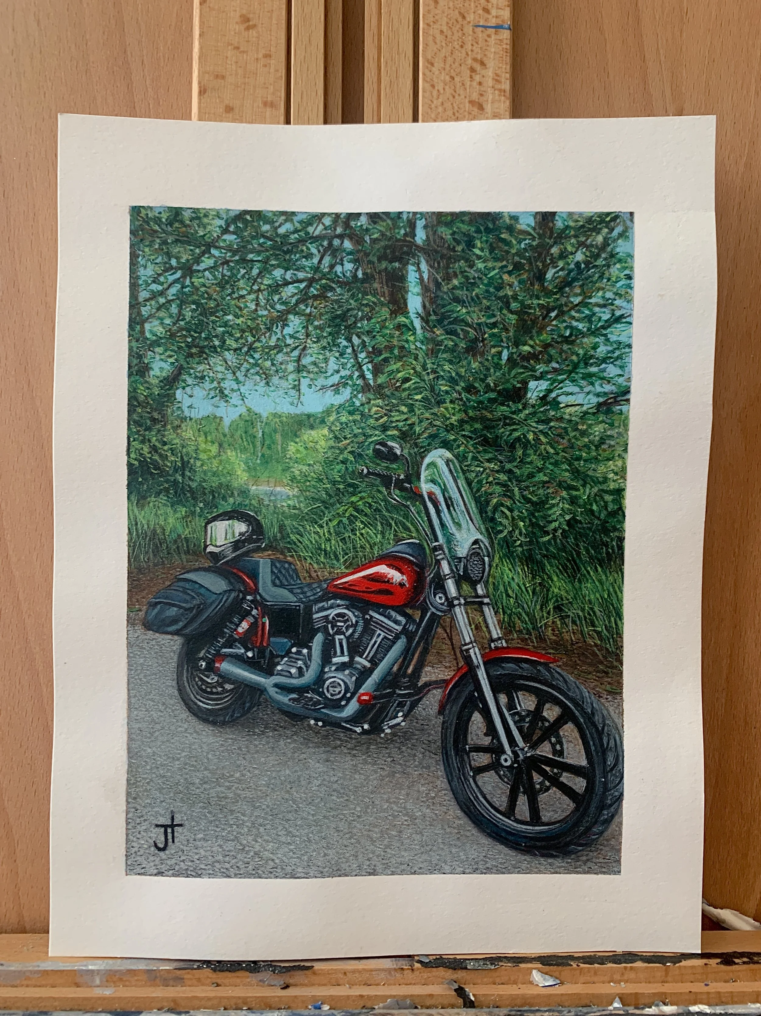 A painting of a red motorcycle parked on a dirt road with greenery and trees in the background.