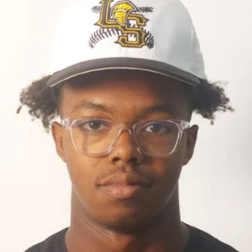 A young man wearing a white baseball cap with a yellow and black logo and clear glasses, facing forward.