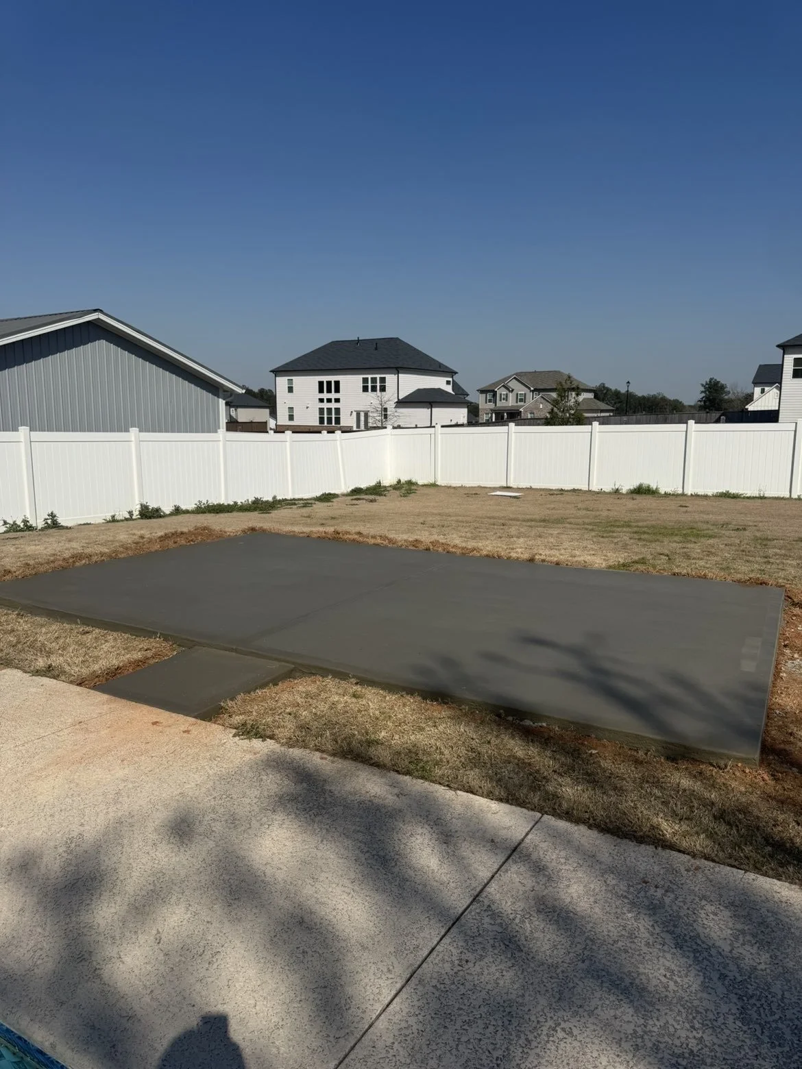 Concrete slab installation completed to create a durable outdoor living space and improve residential property functionality in Middle Georgia.