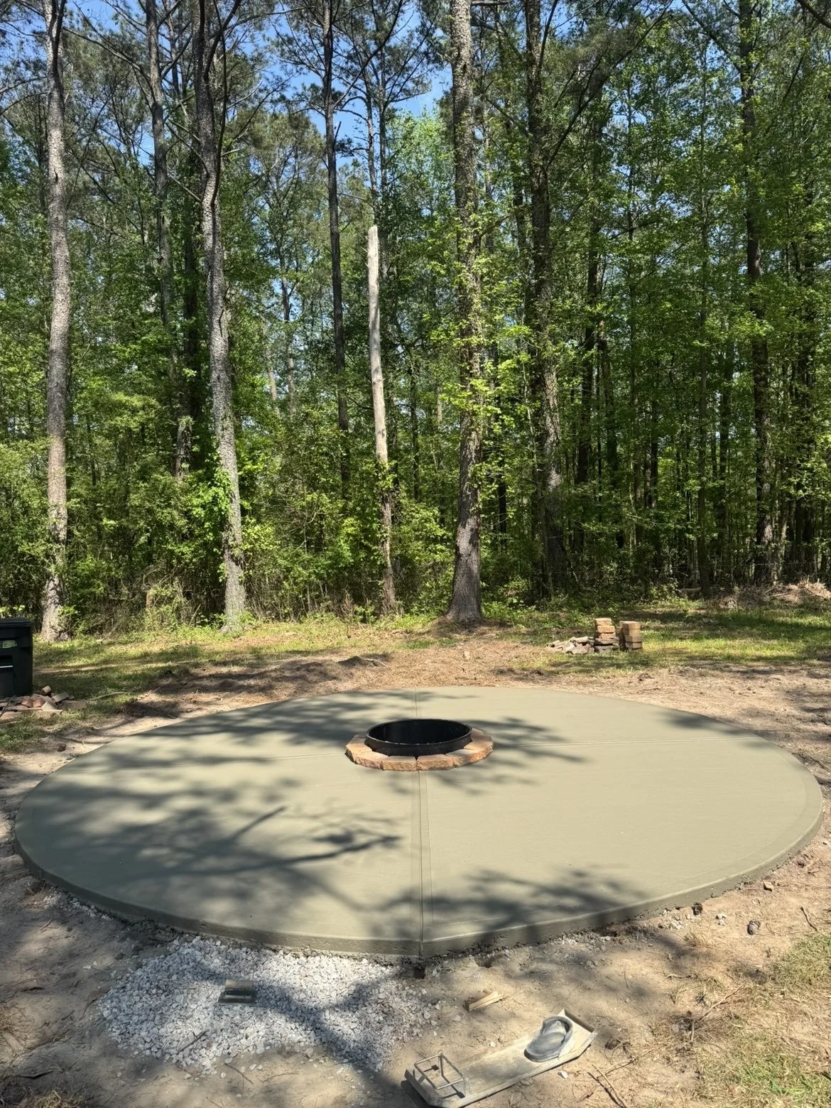 Custom concrete fire pit installation completed to create a functional outdoor gathering space and enhance backyard living in Middle Georgia.