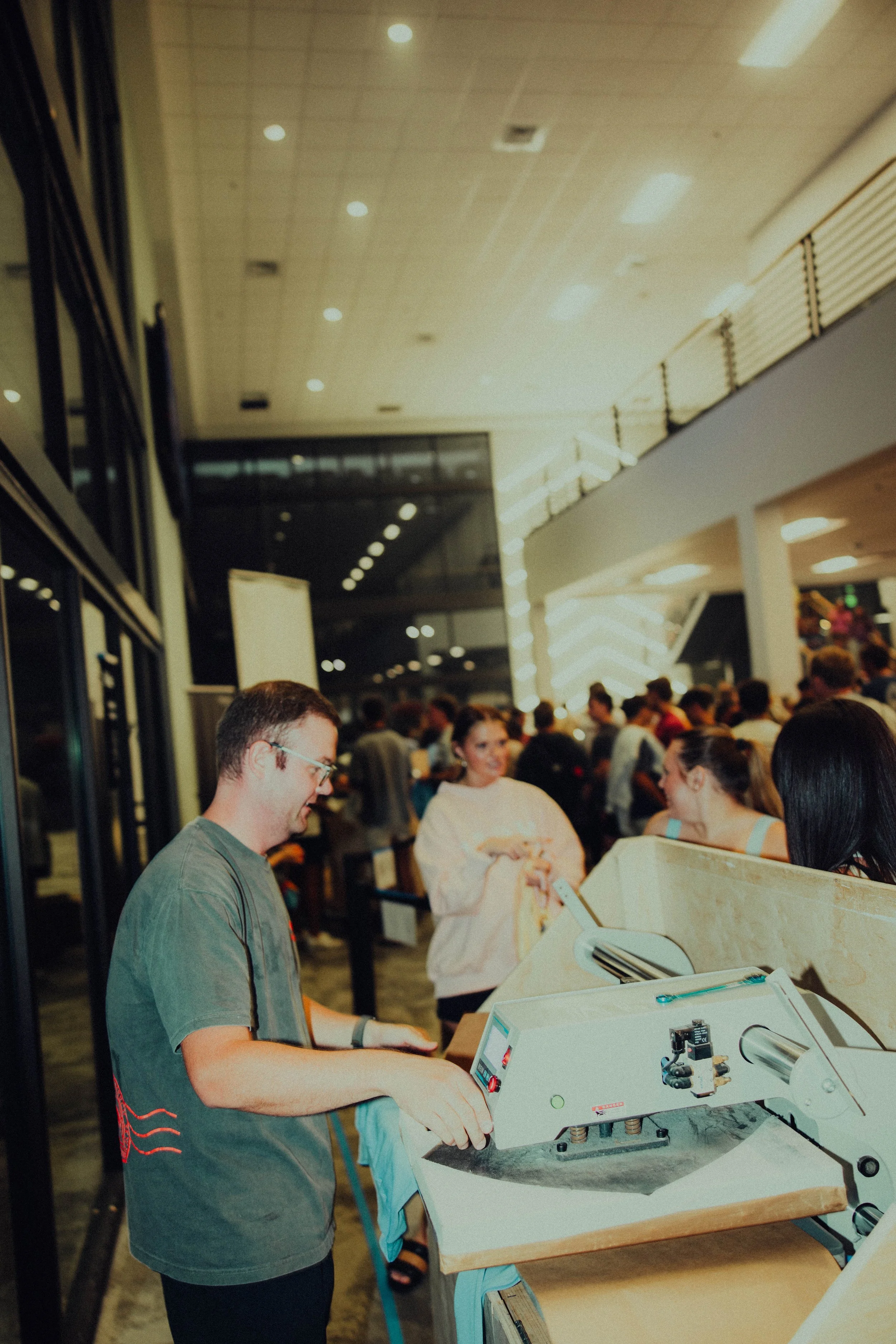 Skyline owner operating a t-shirt press at a church event.