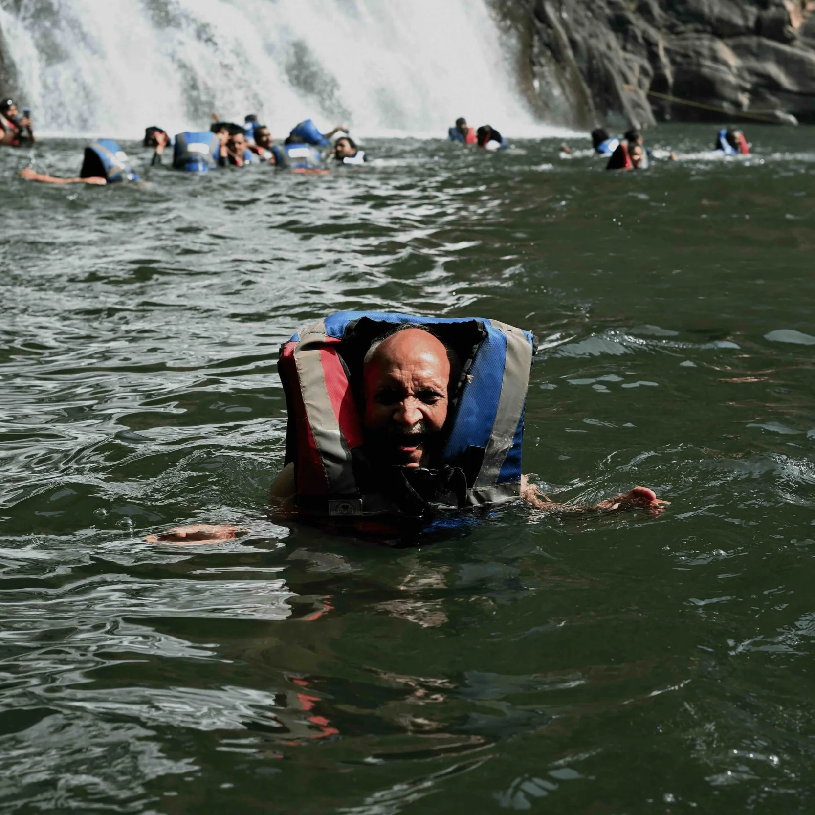 Family Documentaries - Old man having fun under waterfall