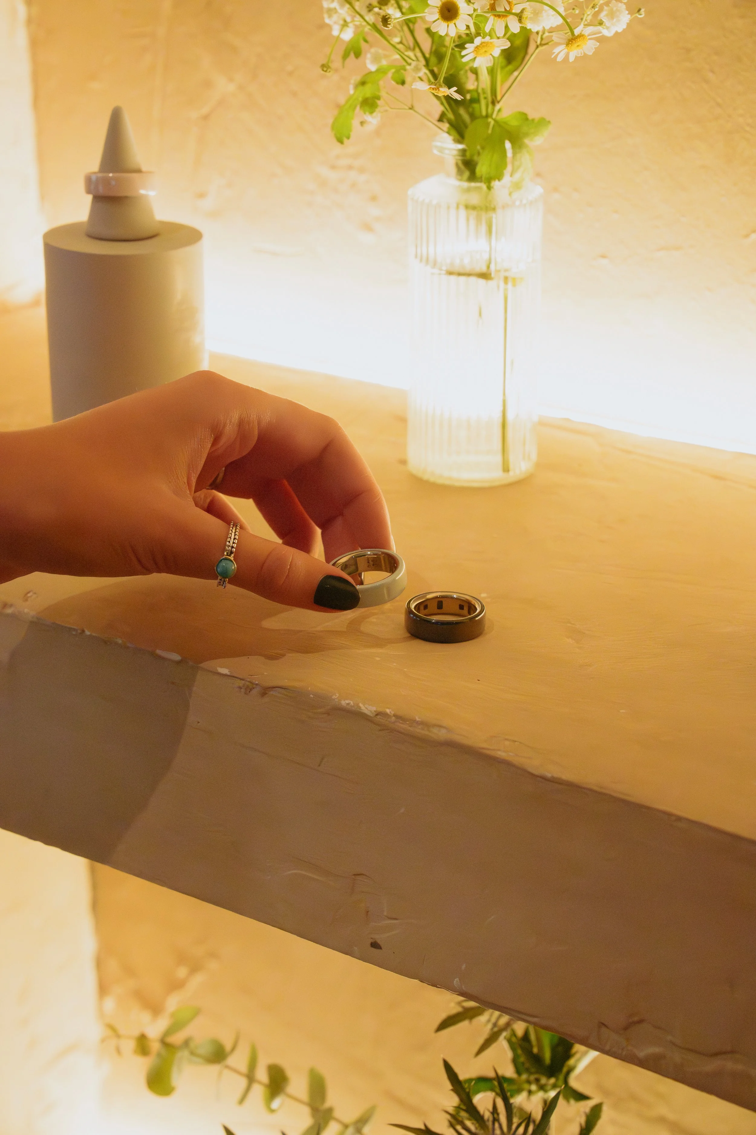 OURA - Ceramic ring being picked up, close up.jpeg