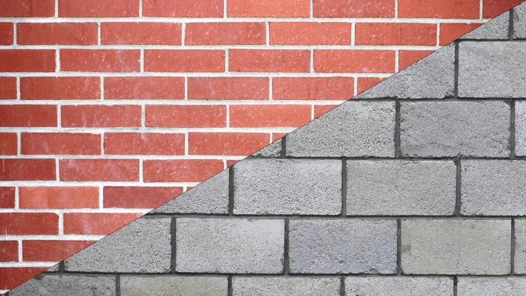 A split image showing a red brick wall on the upper left side and a gray concrete block wall on the lower right side.