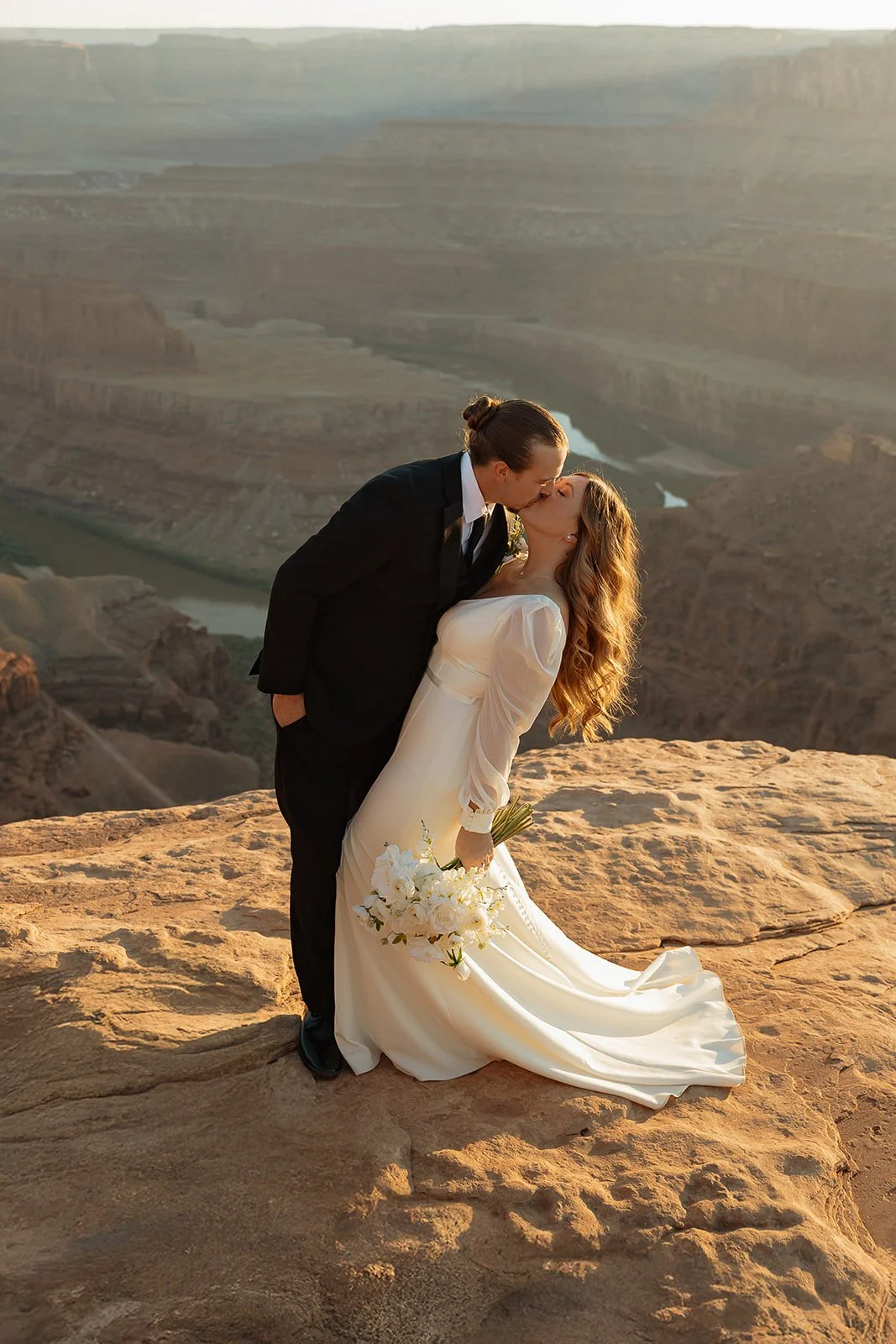 couple shares a kiss after their elopement ceremony in Moab utah