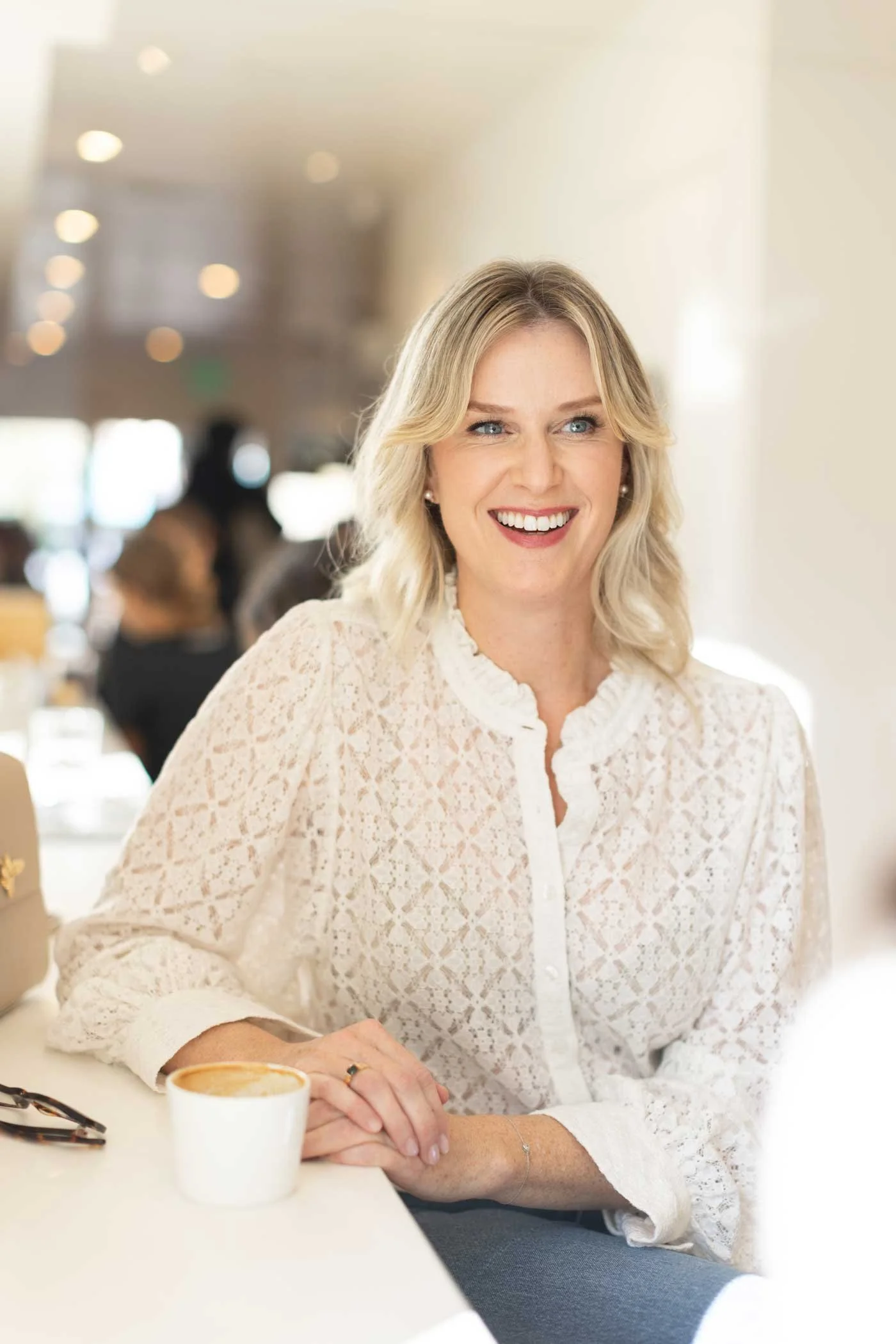 Stephanie Rooney, PhD, San Francisco psychologist, smiling warmly over coffee.