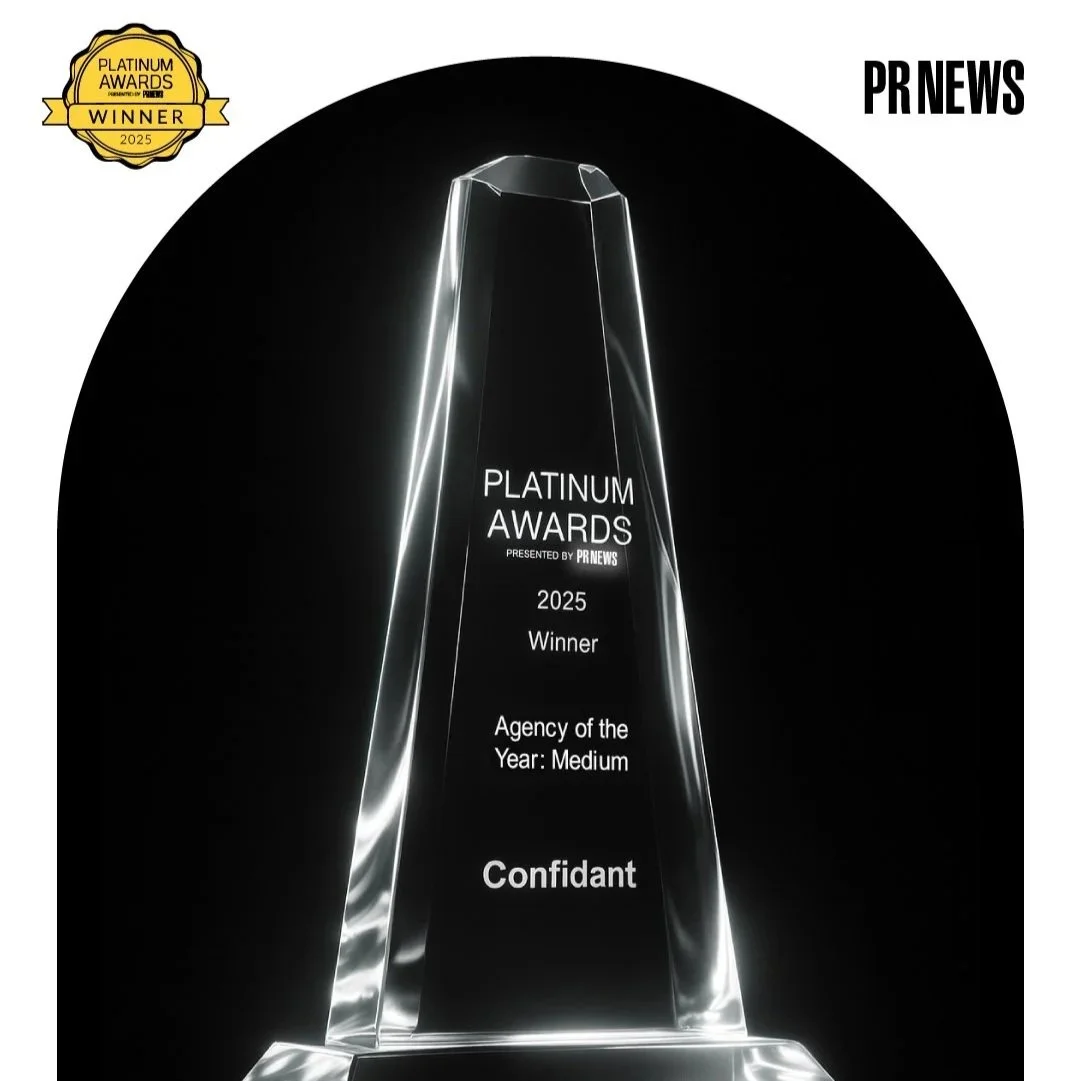 A crystal awards trophy with the inscription "Platinum Awards 2025 Winner Agency of the Year: Medium" presented by PR News, set against a black background.