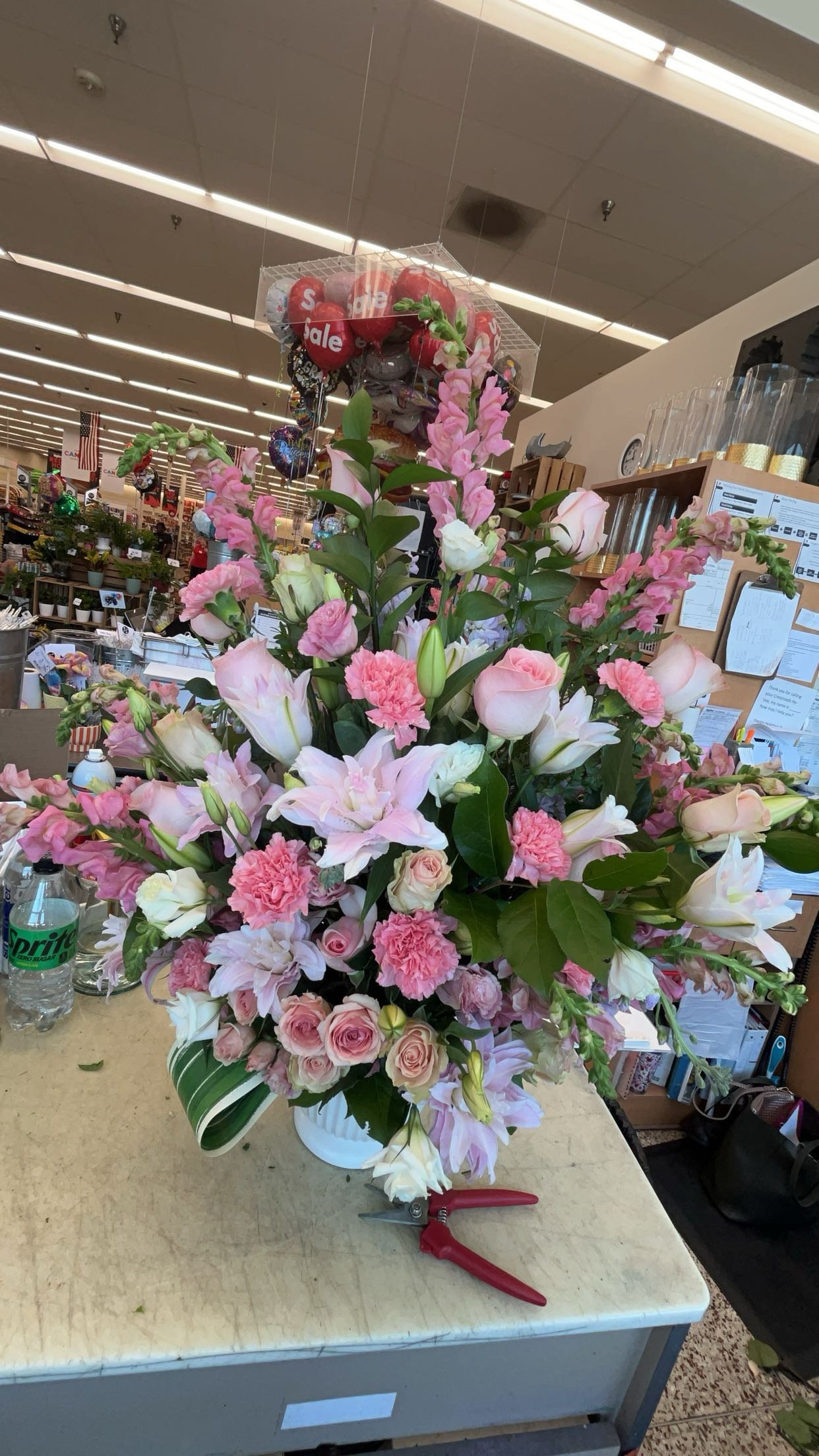 Pink and white flower arrangement on a table in a flower shop.