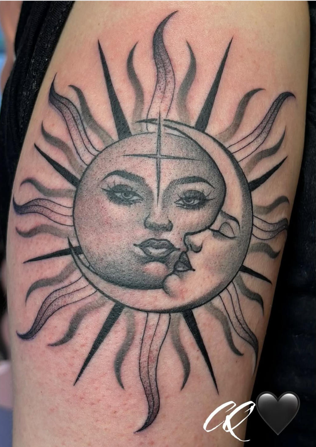 Tattoo of the sun with a face blowing a kiss, featuring a large circular sun with sun rays around it. The face has detailed eyes, lips, and facial features.