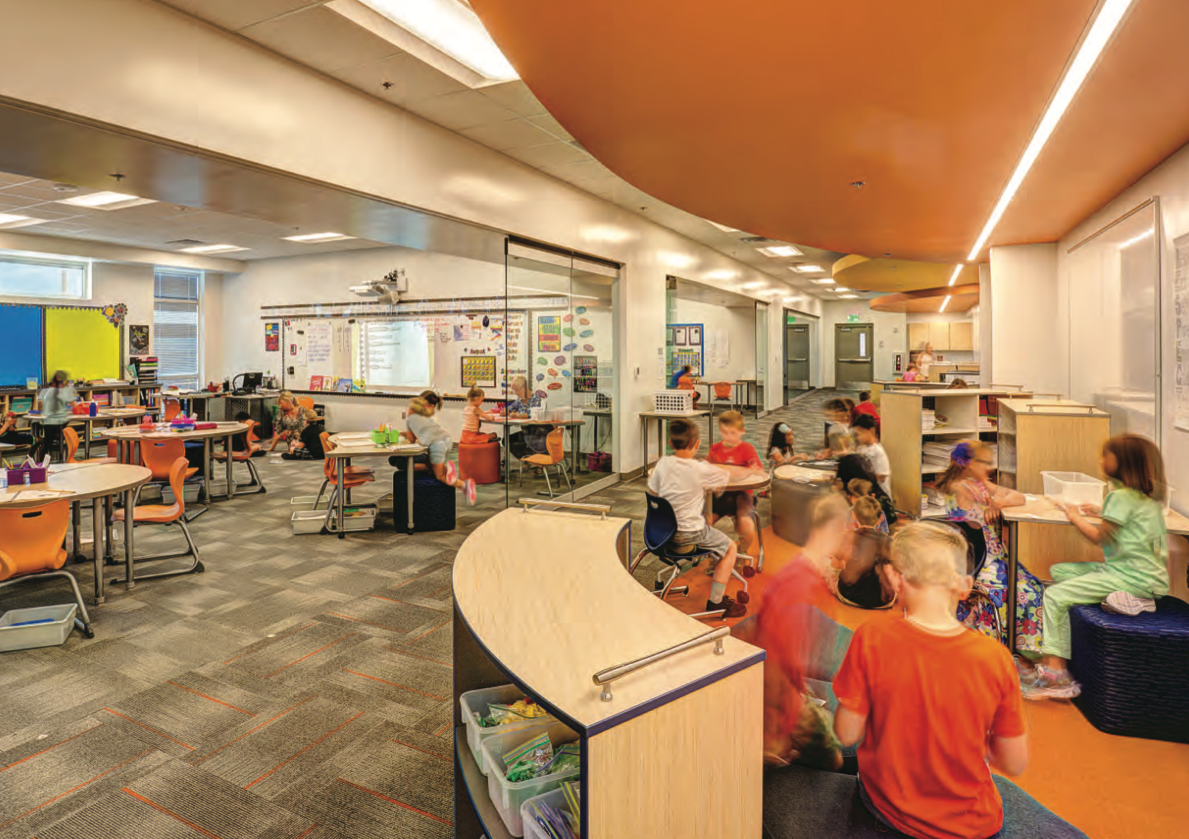 a newly opened elementary school with children learning  in the open concept hallway and classroom