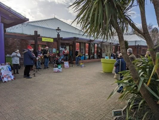 Band members busking outside Haskins Garden Centre