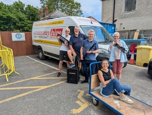 Some band members unloading equipment from van