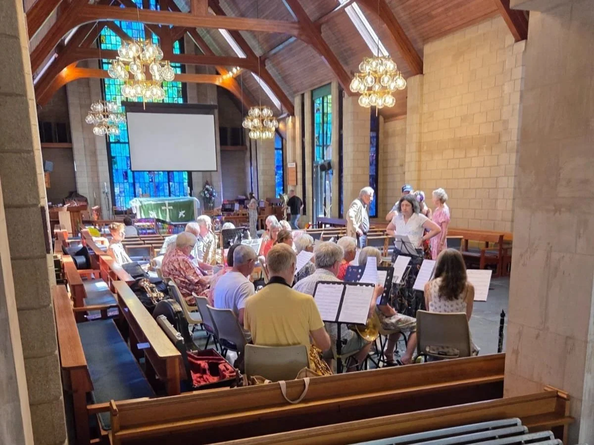 Daytime Community Band preparing for concert in church hall