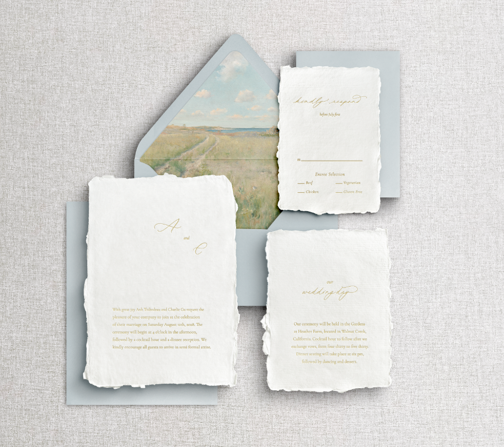 Signature Morning Dew wedding invitation: gold foil letterpress on white handmade deckle edge paper, with misty morning landscape liner on blue envelope.