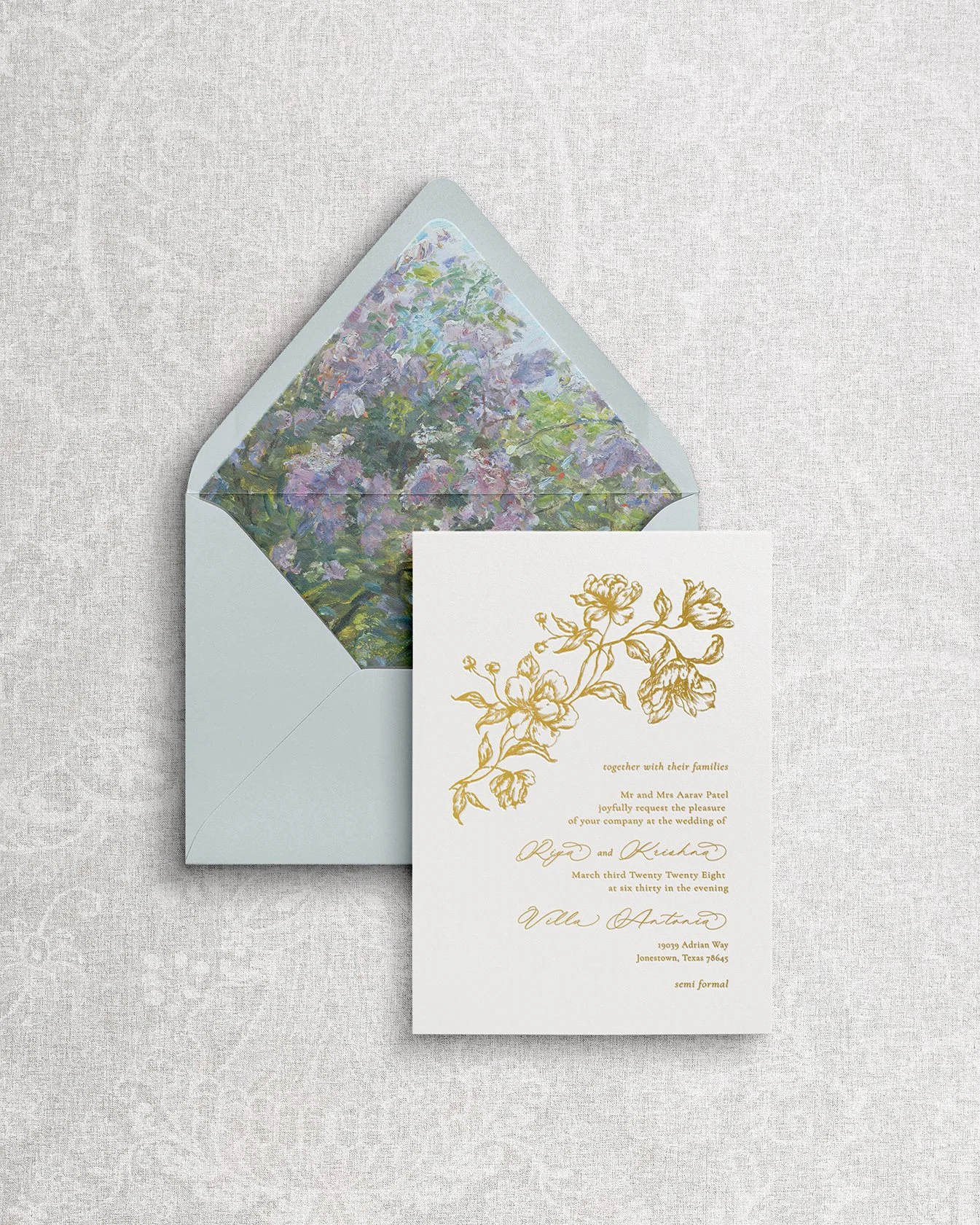 Elegant and simple wedding invitation featuring gold foil calligraphy and a painterly floral envelope liner.