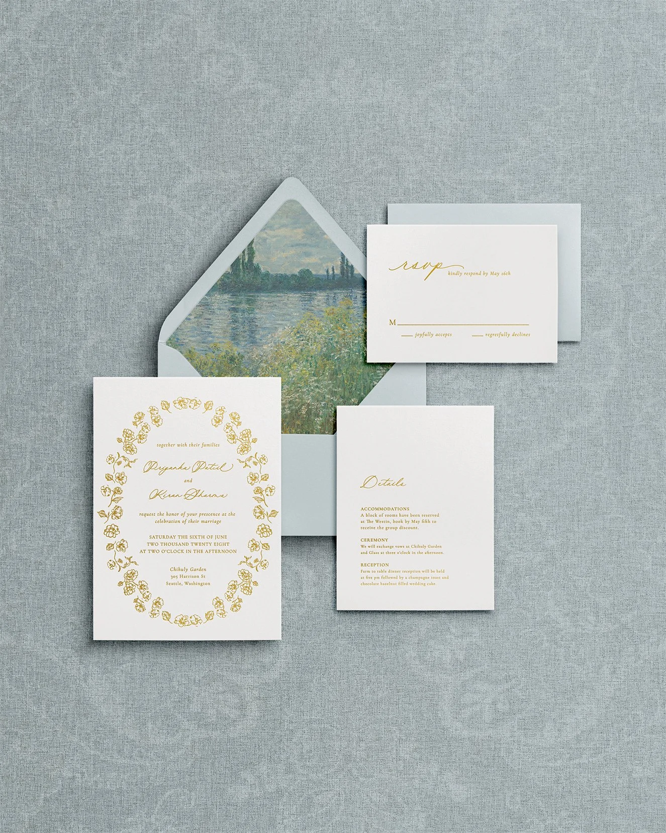 Signature botanical wedding stationery with gold calligraphy, floral border, and dusty blue envelopes on premium matte cardstock.