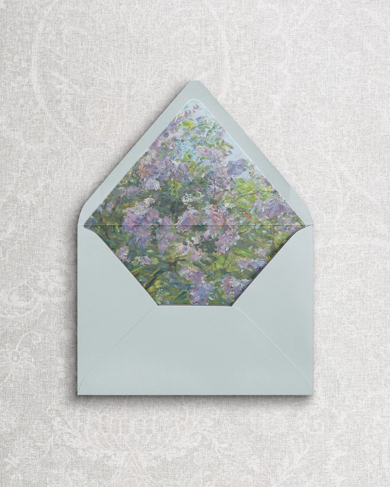 Simple and elegant wedding stationery envelope featuring a painterly floral liner.