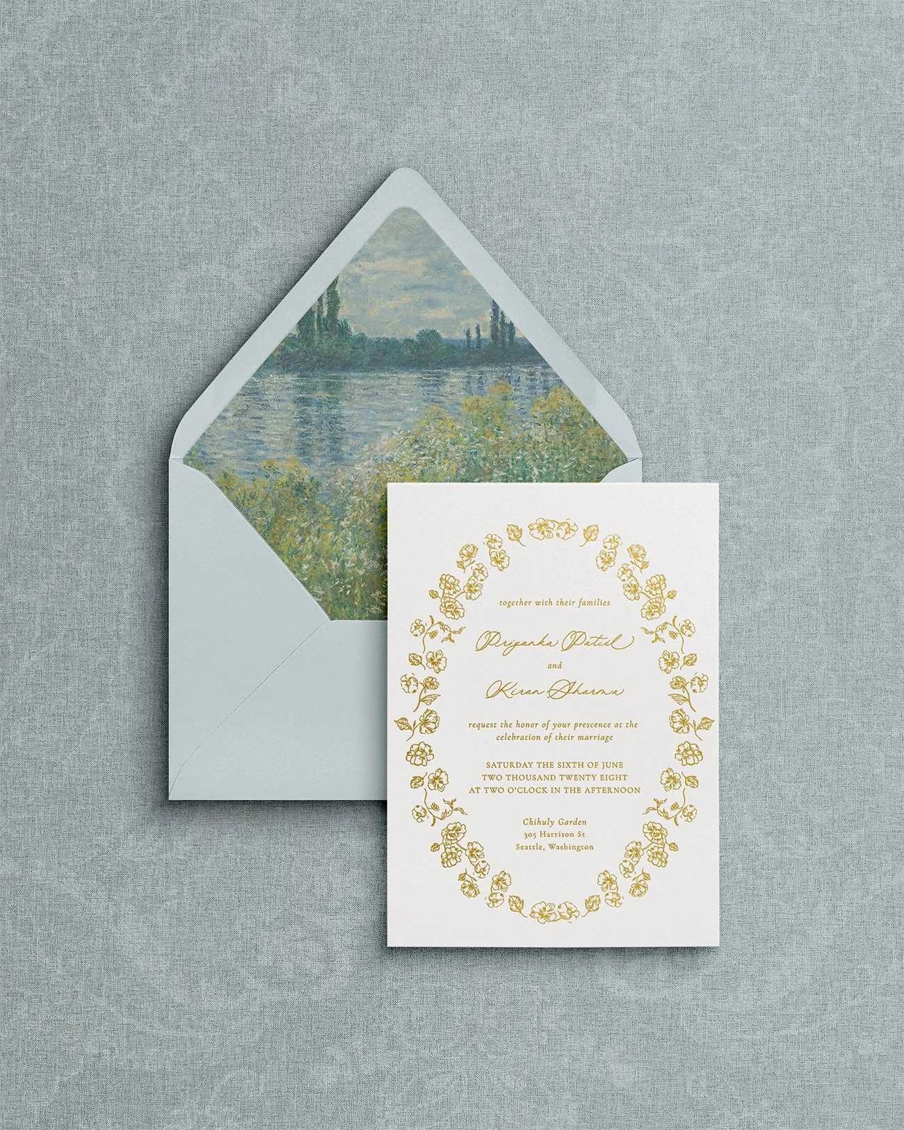 Flora de la mer wedding invitation suite featuring gold foil letterpress calligraphy on premium matte cardstock with blue envelope.