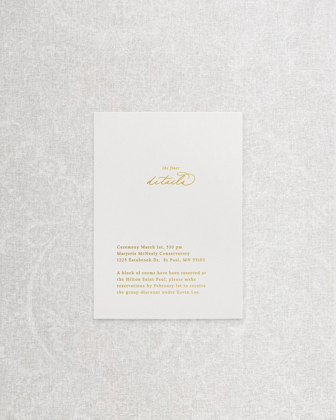 An elegant, simple wedding invitation details card featuring sophisticated gold foil calligraphy on premium cardstock.